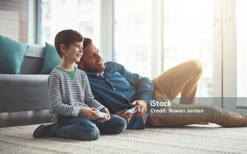 Kid is playing game with father